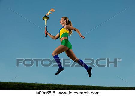 Stock Photo - Brazilian runner carrying Olympic torch. Fotosearch