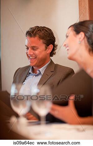 Stock Image - Business people having lunch together. Fotosearch