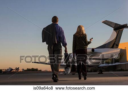 Stock Photo - Business people on airplane runway. Fotosearch