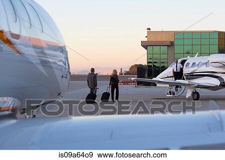 Business people on airplane runway View Large Photo Image Stock Photo - Business people on airplane runway. Fotosearch