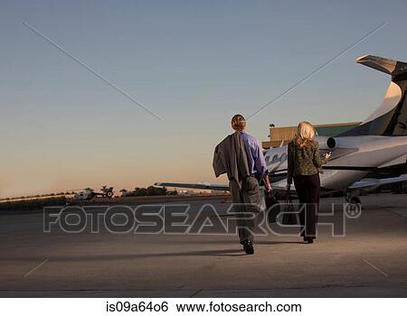 Stock Photograph - Business people on airplane runway. Fotosearch