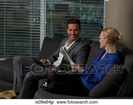 Stock Photography - Business people relaxing on sofa. Fotosearch