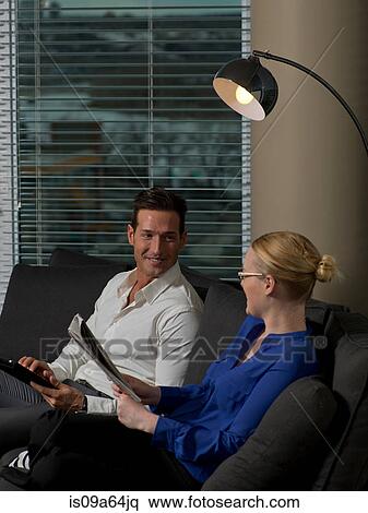 Stock Photography - Business people relaxing on sofa. Fotosearch