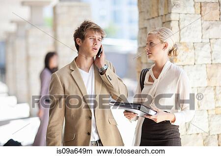 Business people standing in walkway View Large Photo Image Picture - Business people standing in walkway. Fotosearch
