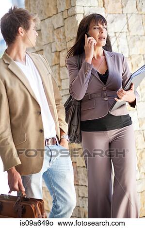 Picture - Business people standing in walkway. Fotosearch