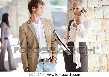 Stock Image - Business people standing in walkway. Fotosearch