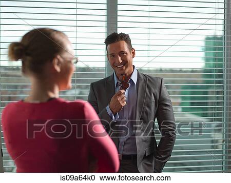 Stock Image - Business people talking in office. Fotosearch