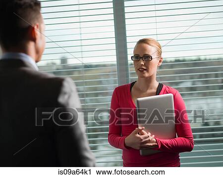 Stock Image - Business people talking in office. Fotosearch