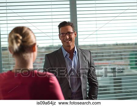 Stock Photo - Business people talking in office. Fotosearch