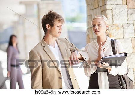 Picture - Business people talking outdoors. Fotosearch