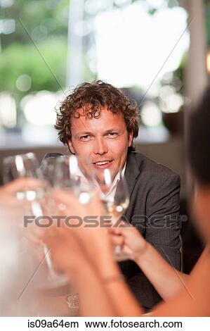 Picture - Business people toasting in restaurant. Fotosearch