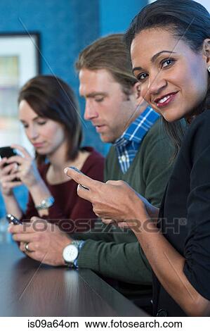 Picture - Business people using cell phones. Fotosearch