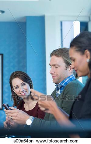 Business people using cell phones View Large Photo Image Picture - Business people using cell phones. Fotosearch