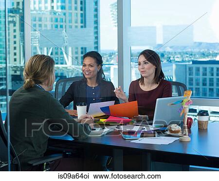 Stock Image - Business people working at desk. Fotosearch
