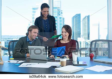 Stock Image - Business people working at desk. Fotosearch