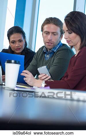 Business people working at desk View Large Photo Image Stock Image - Business people working at desk. Fotosearch