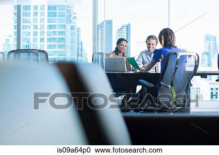 Stock Image - Business people working at desk. Fotosearch