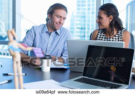 Business people working at desk View Large Photo Image Stock Image - Business people working at desk. Fotosearch