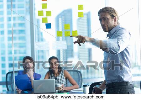 Stock Image - Business people working in office. Fotosearch
