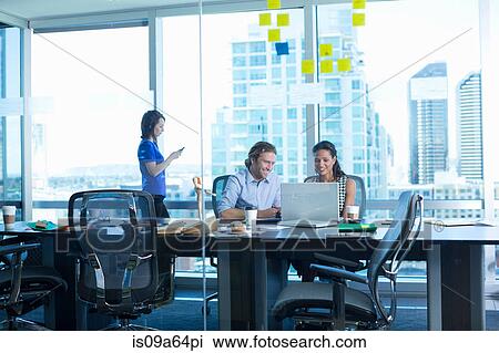 Stock Image - Business people working in office. Fotosearch