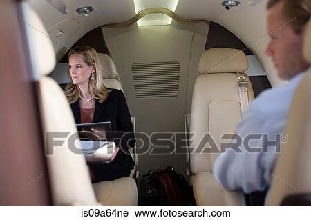 Stock Image - Business people working on airplane. Fotosearch