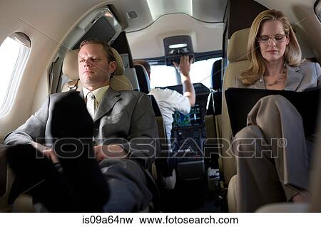 Stock Photo - Business people working on airplane. Fotosearch