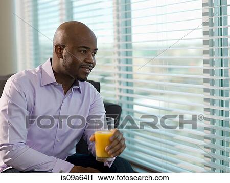 Businessman drinking orange juice View Large Photo Image Stock Image - Businessman drinking orange juice. Fotosearch
