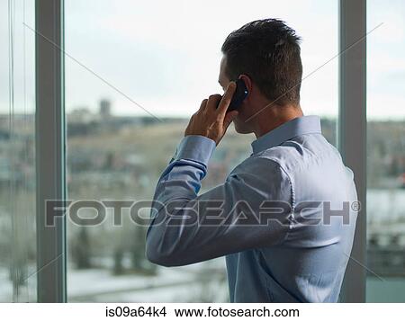 Picture - Businessman talking on cell phone. Fotosearch