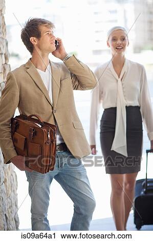 Stock Image - Businessman talking on cell phone. Fotosearch