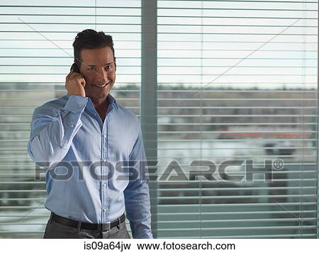 Stock Photo - Businessman talking on cell phone. Fotosearch