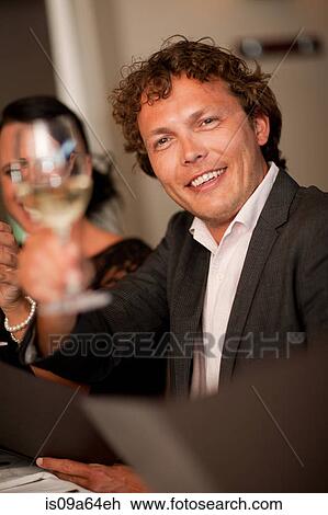 Businessman toasting at dinner table View Large Photo Image Stock Image - Businessman toasting at dinner table. Fotosearch