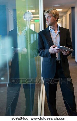 Businessman with tablet in office View Large Photo Image Stock Image - Businessman with tablet in office. Fotosearch