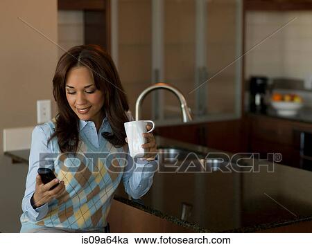 Stock Image - Businesswoman having cup of coffee. Fotosearch