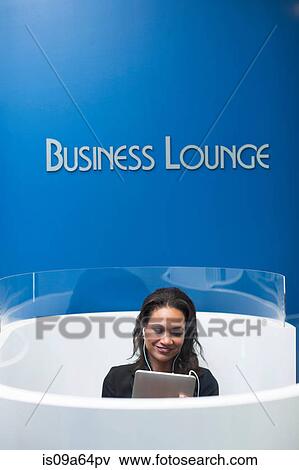 Stock Photo - Businesswoman relaxing in lounge. Fotosearch