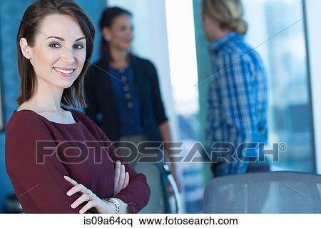 Businesswoman smiling in office View Large Photo Image Stock Photography - Businesswoman smiling in office. Fotosearch