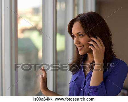 Stock Image - Businesswoman talking cell phone. Fotosearch