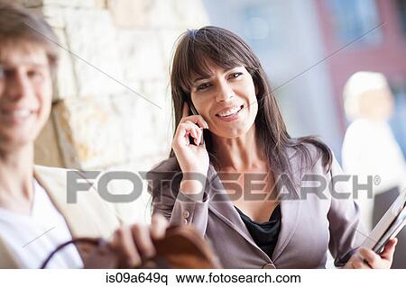 Stock Photography - Businesswoman talking on cell phone. Fotosearch