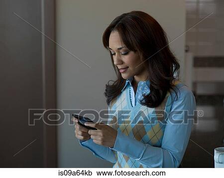 Stock Image - Businesswoman using cell phone. Fotosearch