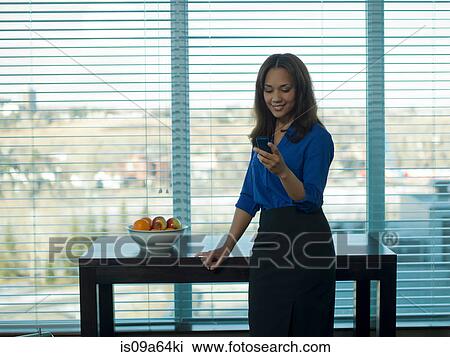 Businesswoman using cell phone View Large Photo Image Stock Image - Businesswoman using cell phone. Fotosearch