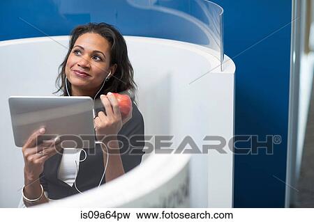 Stock Photo - Businesswoman using tablet computer. Fotosearch