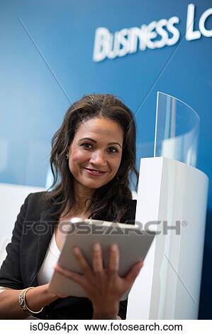 Stock Photo - Businesswoman using tablet computer. Fotosearch