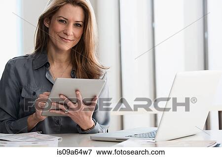 Stock Photo - Businesswoman using tablet computer. Fotosearch