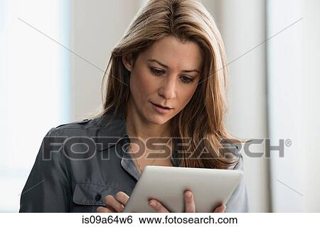Stock Photograph - Businesswoman using tablet computer. Fotosearch