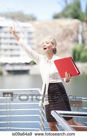 Businesswoman waving from balcony View Large Photo Image Stock Photo - Businesswoman waving from balcony. Fotosearch