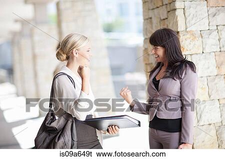 Businesswomen cheering in walkway View Large Photo Image Stock Photograph - Businesswomen cheering in walkway. Fotosearch