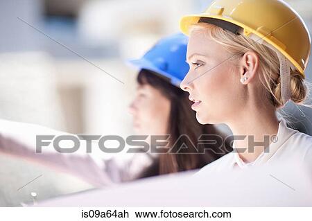 Businesswomen reading blueprints View Large Photo Image Stock Image - Businesswomen reading blueprints. Fotosearch