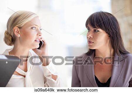 Stock Image - Businesswomen standing outdoors. Fotosearch
