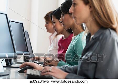Businesswomen working at computers View Large Photo Image Stock Image - Businesswomen working at computers. Fotosearch