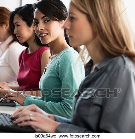 Businesswomen working at computers View Large Photo Image Stock Image - Businesswomen working at computers. Fotosearch