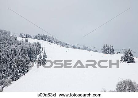 Stock Image - Chairlift on snowy slope. Fotosearch